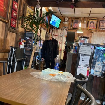 Chilli Thai - a man standing in a restaurant - Thai Near Me - Los Angeles, California