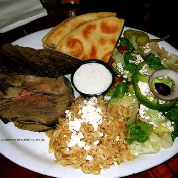 Kafé Neo Edmonds - Slow-roasted marinated boneless lamb served with rice-pilaf, Greek salad, tzatziki sauce + pita. - Greek Near Me - Edmonds, Washington
