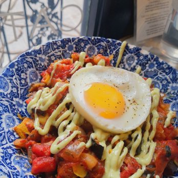 maman - ratatouille hash ratatouille served over crispy smashed potatoes topped with a fried egg, green goddess dressing & cilantro - Breakfast & Brunch Near Me - New York, New York maman - ratatouille hash ratatouille served over crispy smashed potatoes topped with a fried egg, green goddess dressing & cilantro - Breakfast & Brunch Near Me - New York, New York