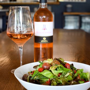 Lupo Italian Kitchen - bowl of salad and a bottle of wine - Italian Near Me - Rehoboth Beach, Delaware Lupo Italian Kitchen - bowl of salad and a bottle of wine - Italian Near Me - Rehoboth Beach, Delaware