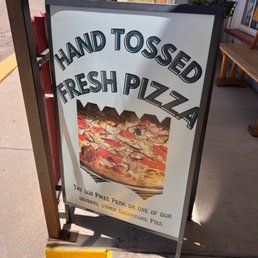 a sign for hand tossed fresh pizza