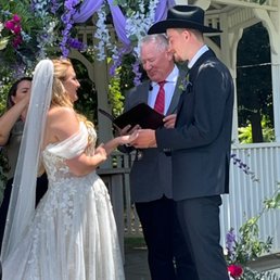 Rev. Mills with our daughter and her groom. Rev. Mills with our daughter and her groom.