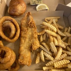Darrell's Place - Fish, onion rings, fries and a nice roll! Came with tarter sauce seems homemade and butter with a lemon wedge! Love what I'm eating!