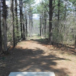 Middlesex Township Park & Coyote Hills Disc Golf Course - Hole 2 Tee shot. Narrow corridor with a sharp dog leg left at the end. Ditches straight ahead and on left.