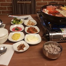 Spicy meat lover stew with traditional korean side dishes Spicy meat lover stew with traditional korean side dishes