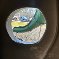 Nature Park - Town of Apex - Slide through tree on playground