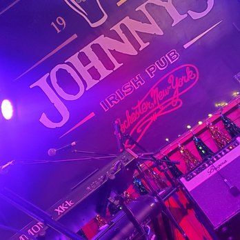 Johnny's Irish Pub - a stage with a guitar and a microphone - Venues & Event Spaces Near Me - Rochester, New York Johnny's Irish Pub - a stage with a guitar and a microphone - Venues & Event Spaces Near Me - Rochester, New York