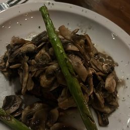 Filet Mignon under the little pile of mushrooms Filet Mignon under the little pile of mushrooms
