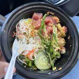 a hand holding a bowl of food a hand holding a bowl of food