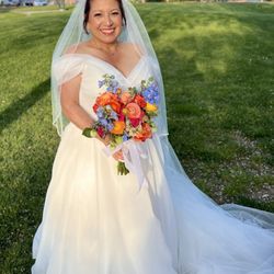 De La Rosa's Bridal & Tuxedos - Wedding dress and veil from De La Rosa Bridal.