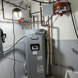 Northstar Plumbing - Mechanical room water heater with recirculating pump and a mop sink.