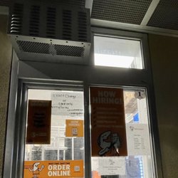 Little Caesars Pizza - Racks stacked up and rolled in front of drive-thru window; nobody working in site or available at the drive-thru speaker or by phone