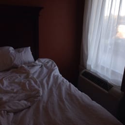 No nightstand, no reading lamp, HVAC unit pointed directly at bed. Not good.