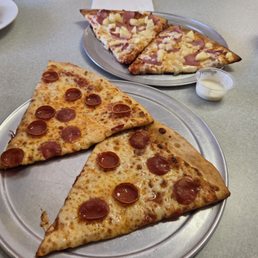 In front pepperoni , in back Hawaiian In front pepperoni , in back Hawaiian