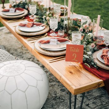 Nineteen27 Vintage Rentals - Pictured: 7 ' low dining table (can turn into standard height as well) ~ 5 x 8 Neutral Vintage Rug ~ White Moroccan Poufs ~ Macrame Pillow. - Party Equipment Rentals Near Me