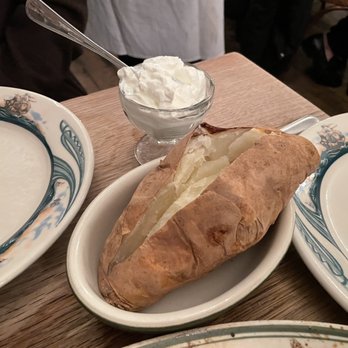 Peter Luger - Baked Oversized Potato with Sour Cream - Steakhouses Near Me - Brooklyn, New York Peter Luger - Baked Oversized Potato with Sour Cream - Steakhouses Near Me - Brooklyn, New York