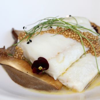 Apple Blossom - The Olive Oil Poached California Halibut is made with king trumpet mushroom, mushroom cream, pickled mustard seed, & green chickpeas. - New American Near Me - Denver, Colorado
