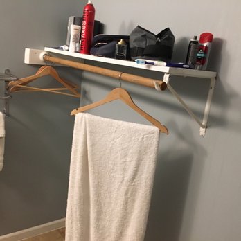 Empire Lakeshore Inn - Place to hang your clothes in the bathroom. Whichever genius did this must like their clothes smelling like toilet. - Hotels Near Me - Empire, Michigan