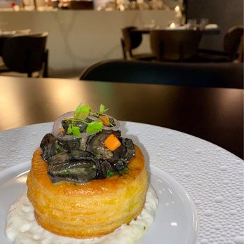 Café Laurel - Escargot on a puff pastry placed on horseradish cream. - French Near Me - Miami, Florida