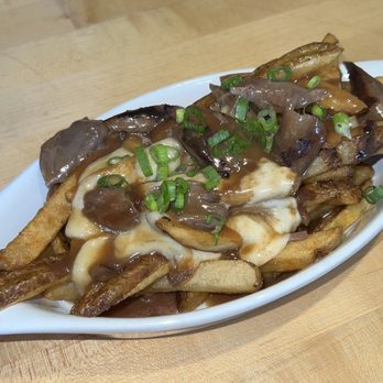 Common Pub - Poutine: Savory Lamb Gravy. Braised Lamb Shanks. Cheese Curds (special) - Pubs Near Me - Detroit, Michigan Common Pub - Poutine: Savory Lamb Gravy. Braised Lamb Shanks. Cheese Curds (special) - Pubs Near Me - Detroit, Michigan