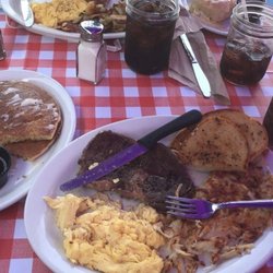 Huckleberry's Breakfast and Lunch - 1/2 ribeye with hash browns garlic bread and two sweet cream flapjacks...sooooo damnnn good