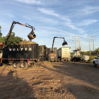 Wolfer Landscape Services - a truck with a crane in the back - Landscaping Near Me - Davie, Florida