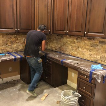 A-2-Z Construction - ows a man working on a kitchen counter - General Contractors Near Me