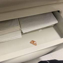 Unicare Community Health Center - Nurse was getting sheets out from this drawer when I looked inside there was a used band-aid inside next to the clean sheets