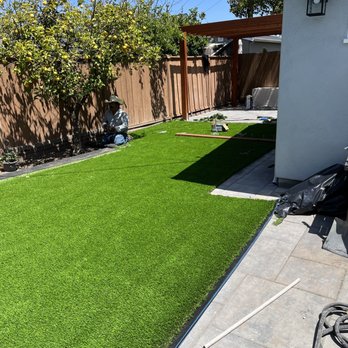 CRC Landscaping - Carlos hard at work installing our new fake grass / artificial turf. - Landscaping Near Me