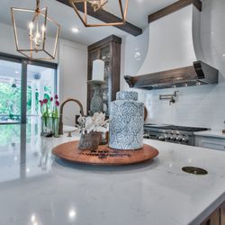 Destin Discount Granite and Cabinets - Misterio quartz with farmhouse sink and pop up outlets