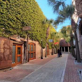 Vincent Chiccos - a narrow street lined with palm trees - Italian Near Me - Charleston, South Carolina