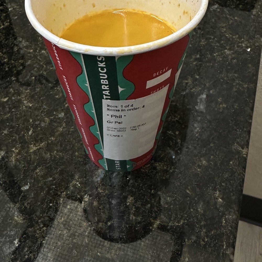 a cup of soup sitting on a counter