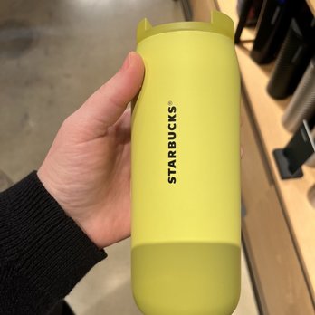 Starbucks - a person holding a yellow cup in a store - Coffee & Tea Near Me - Harrisburg, Pennsylvania Starbucks - a person holding a yellow cup in a store - Coffee & Tea Near Me - Harrisburg, Pennsylvania