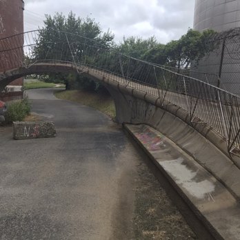 Rootwad Park - The entrance to Rootwad Park from the Riverfront Trail, with access blocked to vehicle traffic by a concrete barrier. - Parks Near Me - St. Louis, Missouri Rootwad Park - The entrance to Rootwad Park from the Riverfront Trail, with access blocked to vehicle traffic by a concrete barrier. - Parks Near Me - St. Louis, Missouri