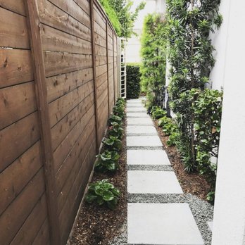 Fire & Flora - a narrow pathway between two houses - Landscaping Near Me - Houston, Texas Fire & Flora - a narrow pathway between two houses - Landscaping Near Me - Houston, Texas