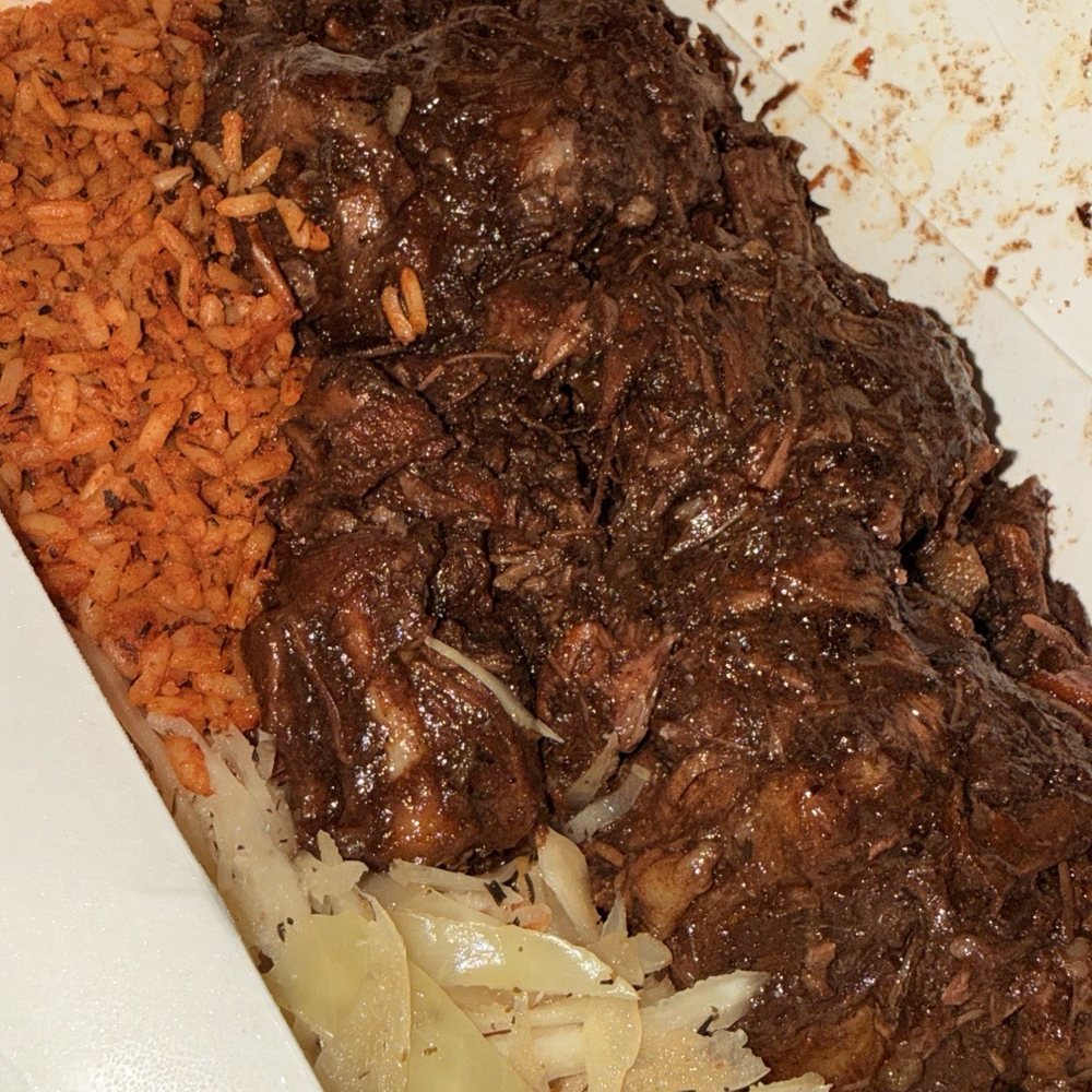 Wah Gwan - Oxtail with jollof rice and cabbage - Caribbean Near Me - Kansas City, Missouri