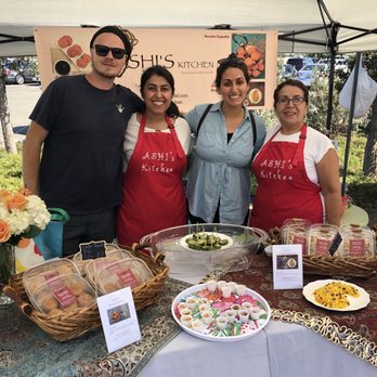 Ashi's Kitchen - a group of people standing in front of a table full of food - Bakeries Near Me - Irvine, California