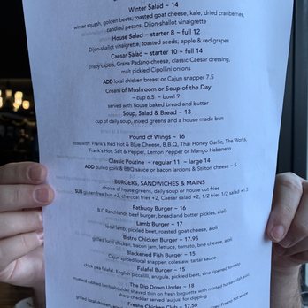 Crooked Goose Bistro - a hand holding a menu - Canadian (New) Near Me - Victoria, British Columbia