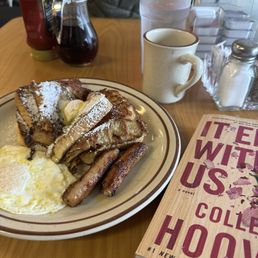 Full order of French toast with sausage and an over easy egg.
