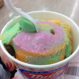 a person holding a cup of ice cream a person holding a cup of ice cream