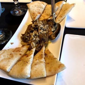 Basil Cafe Restaurant - SAUTEED EGGPLANT TOPPED WITH CRUSHED WALNUTS & CARAMELIZED ONION, SERVED WITH PITA BREAD - Persian/Iranian Near Me - Saint James, New York Basil Cafe Restaurant - SAUTEED EGGPLANT TOPPED WITH CRUSHED WALNUTS & CARAMELIZED ONION, SERVED WITH PITA BREAD - Persian/Iranian Near Me - Saint James, New York