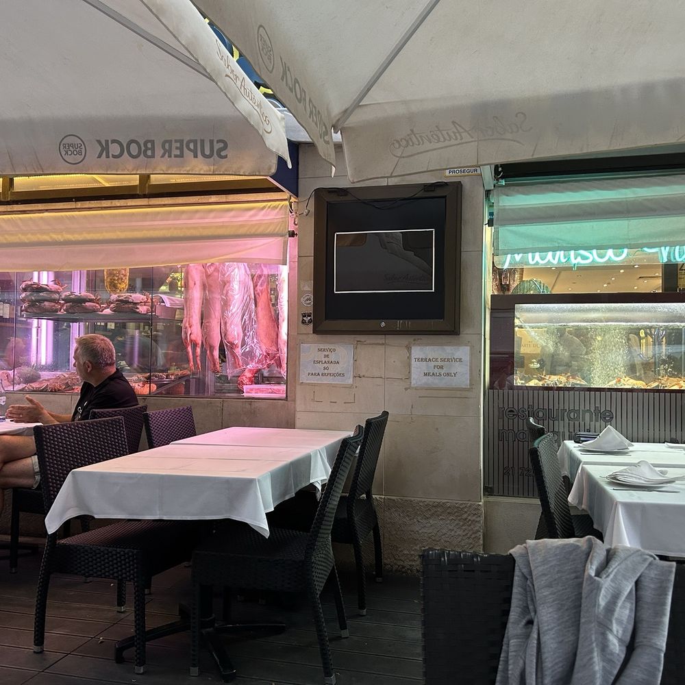 Marquês de Palma - Outdoor seating and fresh meat and seafood in the windows. - Portuguese Near Me - Lisbon, 11