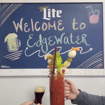 Edgewater - two people toasting a bloody drink - Sports Bars Near Me - Marinette, Wisconsin
