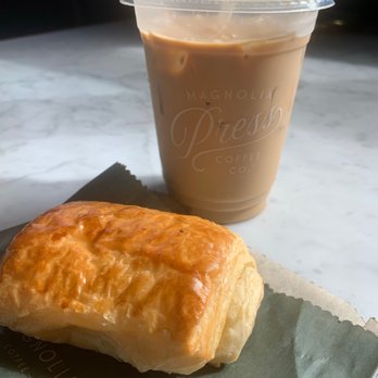 Magnolia Press - Chocolate croissant and 1905 iced coffee (16oz) - Coffee & Tea Near Me - Waco, Texas