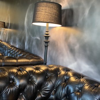 Cloak & Dagger Wines - a black leather couch and lamp - Wineries Near Me - Paso Robles, California