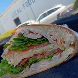 Sebastopol Liquor & Delicatessen - #13. Turkey Club 13.99 yummy club sandwich with lots of turkey and crispy bacon, lettuce, tomato, mayo, sliced in the middle