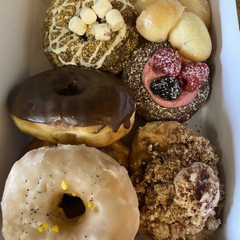 Sara’s Donut Story - Assortment of donuts and donut holes - s'mores, raspberry, chocolate, cinnamon dust, and lemon. - Donuts Near Me - Flower Mound, Texas