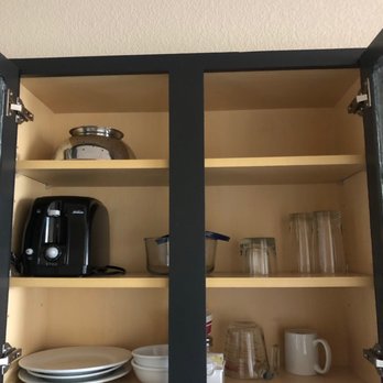 Candlewood Suites Turlock - Cupboards with provided items (there is 1 additional mug and 2 glass Tupperware of different sizes not pictured) - Hotels Near Me - Turlock, California Candlewood Suites Turlock - Cupboards with provided items (there is 1 additional mug and 2 glass Tupperware of different sizes not pictured) - Hotels Near Me - Turlock, California