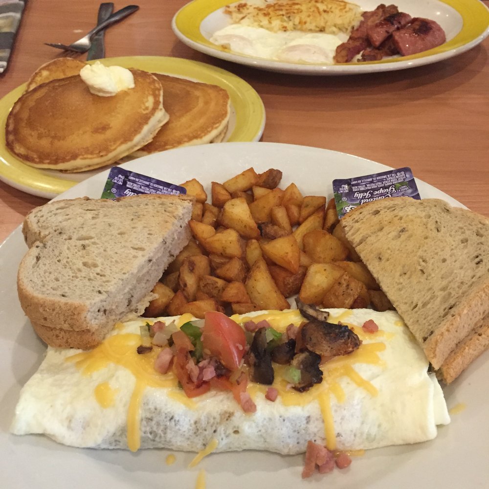 Center: the Everything omelet with egg whites, breakfast potatoes and rye toast. Top: the Smokehouse breakfast with pancakes.