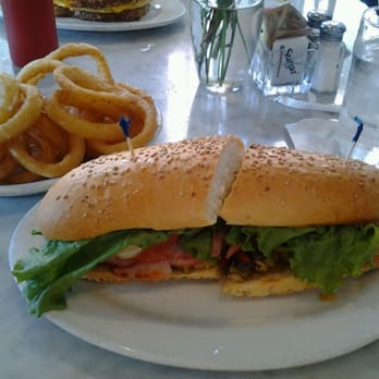 Stanley - Muffelatta po boy...yummy! Couldn't finish it!..huge! (beer battered onion rings in the back) - Breakfast & Brunch Near Me - New Orleans, Louisiana
